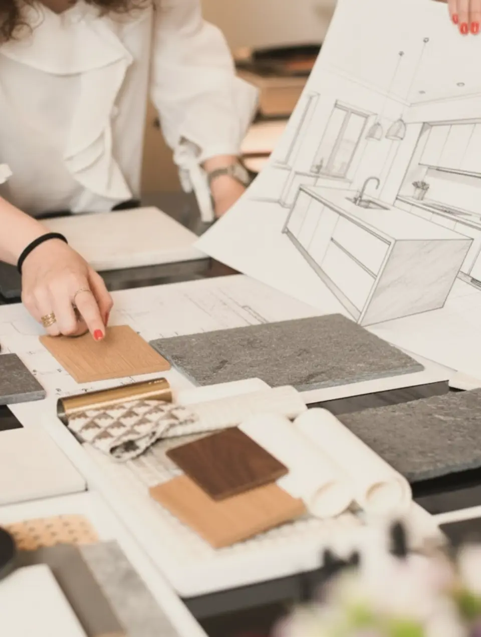 Work selecting materials for a kitchen designed by Margarida Bugarim. On the table are samples of marble and wood.